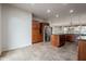 Gourmet kitchen with stainless steel fridge, granite countertops, island, and ample cabinet space at 28837 N 127Th Ave, Peoria, AZ 85383