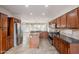 Open kitchen design with dark cabinets, stainless appliances, and granite countertops overlooking the living area at 28837 N 127Th Ave, Peoria, AZ 85383