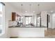 Modern kitchen with granite countertops, stainless steel appliances, and open bar seating at 28837 N 127Th Ave, Peoria, AZ 85383