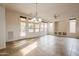 Spacious living area with tile flooring, modern lighting, and access to the outdoor patio at 28837 N 127Th Ave, Peoria, AZ 85383