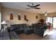 Spacious living room with large sofa, ceiling fan, and tile flooring at 2941 N Oregon St # 12, Chandler, AZ 85225