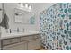 Bathroom featuring white countertop vanity, decorative mirror, and colorful cactus-themed shower curtain at 3175 E Merrill Ave, Gilbert, AZ 85234