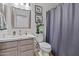Bathroom with a large vanity, framed mirror, toilet, and shower with modern fixtures at 3175 E Merrill Ave, Gilbert, AZ 85234