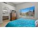 Bright bedroom featuring a tiled floor, ensuite bathroom, and a window view of the backyard pool at 3175 E Merrill Ave, Gilbert, AZ 85234
