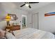 Bright bedroom with a decorative lamp, en-suite bathroom access, and closet with shelving at 3175 E Merrill Ave, Gilbert, AZ 85234