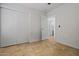 Empty bedroom featuring neutral walls, neutral tile flooring, closet, and an en-suite bathroom at 3175 E Merrill Ave, Gilbert, AZ 85234