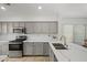 Modern kitchen with sleek countertops, stainless steel appliances, and ample cabinet space at 3175 E Merrill Ave, Gilbert, AZ 85234
