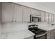 Bright kitchen featuring quartz countertops, stainless steel appliances, and stylish gray cabinetry at 3175 E Merrill Ave, Gilbert, AZ 85234