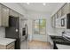 Bright kitchen featuring stainless steel appliances, a garden window, and stylish gray cabinetry at 3175 E Merrill Ave, Gilbert, AZ 85234