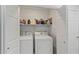 Convenient laundry closet featuring a washer and dryer, and storage shelves for added functionality at 3175 E Merrill Ave, Gilbert, AZ 85234