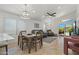 Open-concept living and dining area boasts tile flooring, recessed lighting, and sliding glass doors to the pool at 3175 E Merrill Ave, Gilbert, AZ 85234