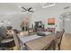 Bright living and dining area with tile floors, ceiling fan, and sliding glass doors opening to the backyard at 3175 E Merrill Ave, Gilbert, AZ 85234