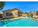 Backyard swimming pool area complete with lounge chairs, landscaping, and a covered patio with a ceiling fan at 3175 E Merrill Ave, Gilbert, AZ 85234