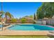 Large swimming pool with a built-in spa and sunbathing deck, surrounded by lush backyard landscaping at 3175 E Merrill Ave, Gilbert, AZ 85234