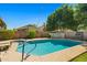 Backyard pool area with lounge chairs, a covered patio, and mature trees, creating a relaxing outdoor space at 3175 E Merrill Ave, Gilbert, AZ 85234