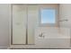 This bathroom features a soaking tub, a glass shower, and a bright window at 3796 E Rakestraw Ln, Gilbert, AZ 85298