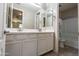 Bathroom vanity area with double sinks, white cabinets, and modern fixtures at 3796 E Rakestraw Ln, Gilbert, AZ 85298