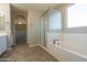 Bathroom featuring a tub, shower, and an archway leading to another room at 3796 E Rakestraw Ln, Gilbert, AZ 85298