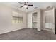 This bedroom features a closet, a ceiling fan and a window at 3796 E Rakestraw Ln, Gilbert, AZ 85298