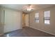 Spacious bedroom featuring carpet floors, neutral paint, closet with sliding doors, and bright natural light at 3796 E Rakestraw Ln, Gilbert, AZ 85298