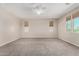 A large bedroom features neutral walls and carpet, with multiple windows offering natural light at 3796 E Rakestraw Ln, Gilbert, AZ 85298