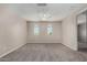 This bedroom has carpet and arched windows at 3796 E Rakestraw Ln, Gilbert, AZ 85298