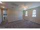 Large bedroom with laundry room access, carpet floors, three windows, and neutral paint at 3796 E Rakestraw Ln, Gilbert, AZ 85298