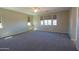 Large bonus room with lots of natural light, carpet and a ceiling fan at 3796 E Rakestraw Ln, Gilbert, AZ 85298
