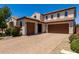 Inviting two-story home featuring a three-car garage, brick driveway and well-manicured landscaping at 3796 E Rakestraw Ln, Gilbert, AZ 85298