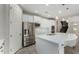 Kitchen featuring stainless steel appliances, a large island, white cabinets, and convenient access to the staircase at 3796 E Rakestraw Ln, Gilbert, AZ 85298