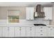 Kitchen features white cabinets, stainless steel appliances, modern backsplash, and expansive countertop space at 3796 E Rakestraw Ln, Gilbert, AZ 85298