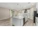 An open concept kitchen featuring an island, white cabinets, stainless steel appliances, and plenty of counter space at 3796 E Rakestraw Ln, Gilbert, AZ 85298