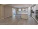Open-concept kitchen with white cabinets, stainless steel appliances, island, and access to outdoor patio at 3796 E Rakestraw Ln, Gilbert, AZ 85298