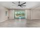 Bright living room showcasing tile floors, neutral walls, a ceiling fan and sliding doors to the outdoor pool at 3796 E Rakestraw Ln, Gilbert, AZ 85298