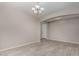 Empty living room showcasing tile floors, neutral walls, and a modern chandelier at 3796 E Rakestraw Ln, Gilbert, AZ 85298