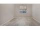 Empty living room with tile floors, neutral walls, and a bright window offering natural light at 3796 E Rakestraw Ln, Gilbert, AZ 85298