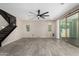 Large living room showing tile floors, neutral walls, stairs and sliding glass doors at 3796 E Rakestraw Ln, Gilbert, AZ 85298
