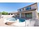 Inviting backyard pool and spa with beautiful patio, fencing, and a view of the home's exterior at 3796 E Rakestraw Ln, Gilbert, AZ 85298