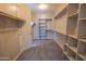 Large walk-in closet featuring carpeted floors, built-in shelving, and storage racks at 3796 E Rakestraw Ln, Gilbert, AZ 85298