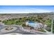 Aerial view showcasing a community's amenities, including a pool, playground, and green spaces, set against a mountain backdrop at 3881 E Galveston St, Gilbert, AZ 85295