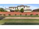 Exterior image of a home featuring a lush green lawn and a tall brick wall at 3881 E Galveston St, Gilbert, AZ 85295