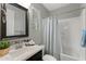 Neutral bathroom featuring a black framed mirror, a shower and bathtub combo, and a single sink vanity at 3881 E Galveston St, Gilbert, AZ 85295