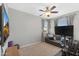 A bedroom features a ceiling fan, large windows and comfortable seating with pillows at 3881 E Galveston St, Gilbert, AZ 85295