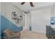 A bedroom featuring a neutral wall color with blue accent and gray chair at 3881 E Galveston St, Gilbert, AZ 85295