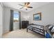 A bedroom features a twin size bed, dresser, a ceiling fan and view of the street at 3881 E Galveston St, Gilbert, AZ 85295