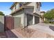 A side view of the home with a three car garage and small landscaping at 3881 E Galveston St, Gilbert, AZ 85295