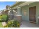 A covered front porch featuring brick columns, flower pots and lush landscaping at 3881 E Galveston St, Gilbert, AZ 85295