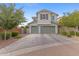 Inviting home with an attached three car garage, lush landscaping and a brick trimmed driveway at 3881 E Galveston St, Gilbert, AZ 85295