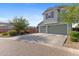 Three-car garage with a spacious driveway and low maintenance landscape at 3881 E Galveston St, Gilbert, AZ 85295