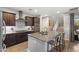Modern kitchen with an island, granite countertops, and stainless steel appliances at 3881 E Galveston St, Gilbert, AZ 85295
